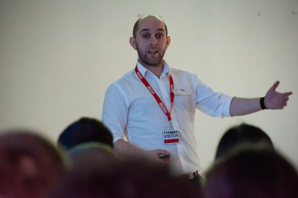 Photograph of a Network Rail representative delivering a talk to a group of seated students