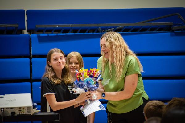 Photo of Mrs Read giving a student a prize, both are smiling