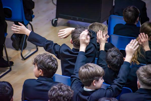 Photo of students waving their arms
