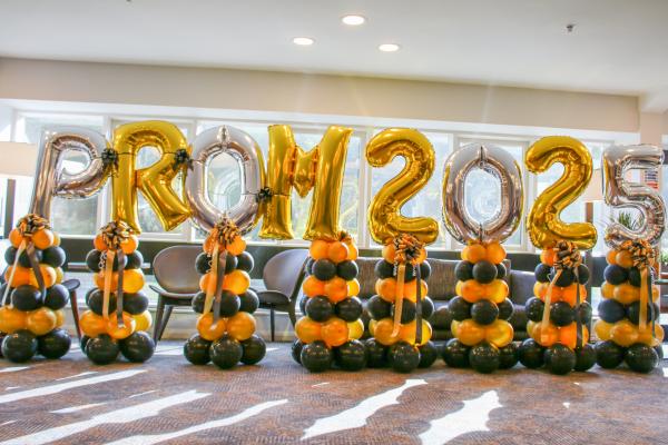 Photo of balloons spelling Prom 2025 in gold and silver